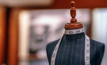 sewing mannequin on display in a store draped with a sewing measure tape