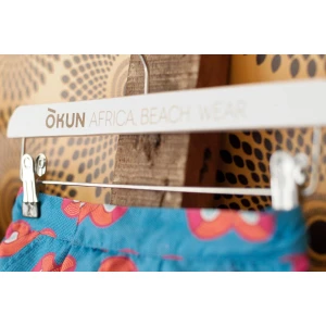 White Wooden Clothes Hangers, Printed With Logo - Okun Africa. Beach. Wear.